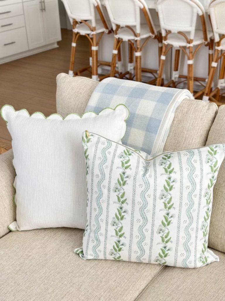 a green scalloped throw pillow on a couch