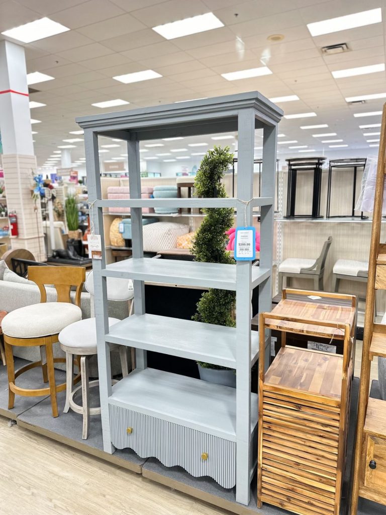a tall blue scalloped bookcase