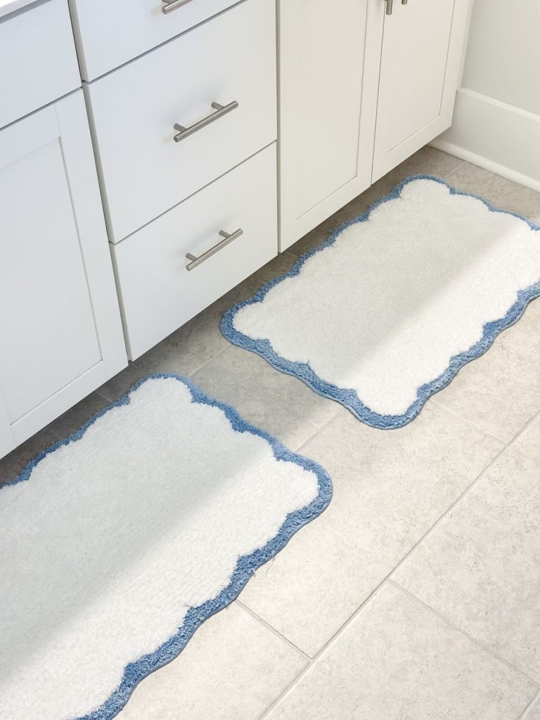 two scalloped bathroom mats in a bathroom